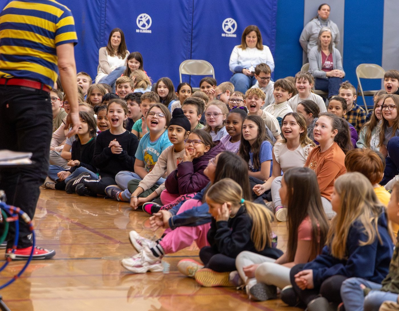 Kids in an audience laughing at Mr. Twisty